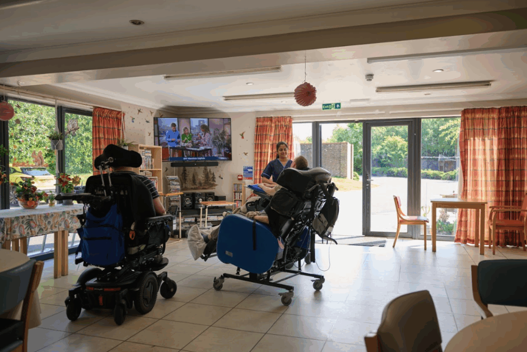 Residents in a communal space with nurse