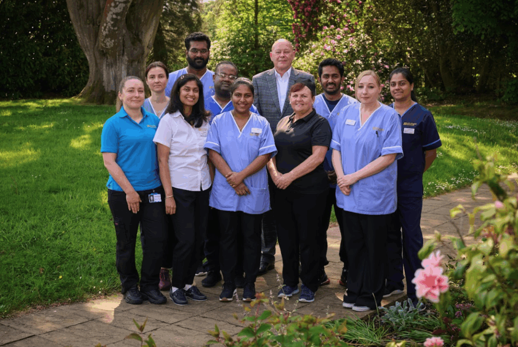 group staff photo outside the care home