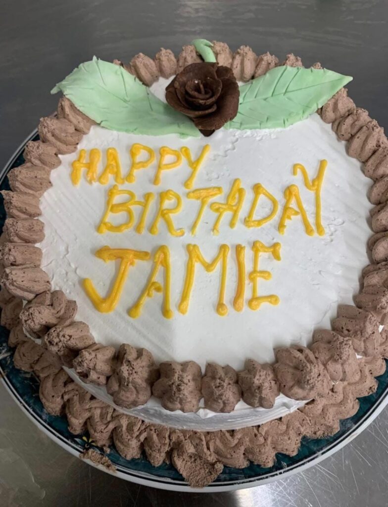 resident birthday cake that reads Jamie in icing