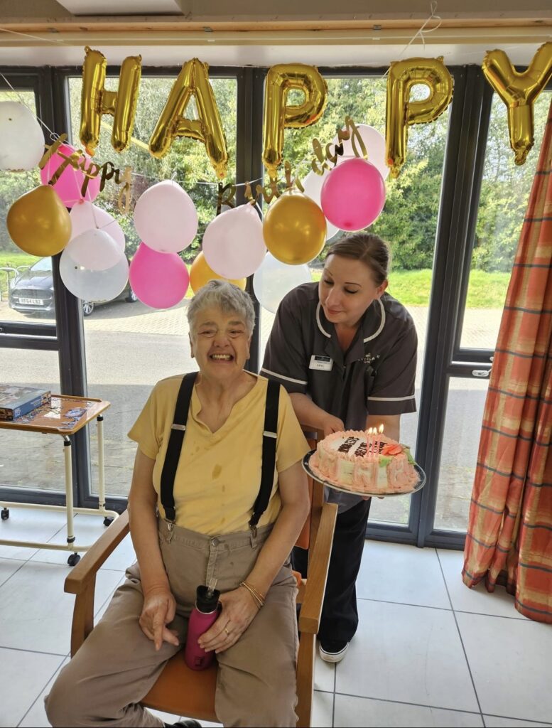 Resident celebrating their birthday with cake.